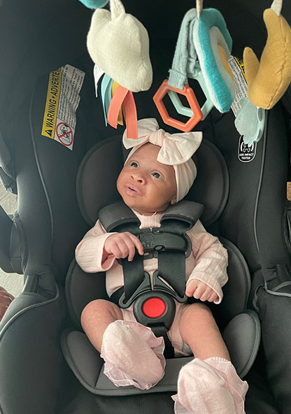 Baby Raya in her car seat