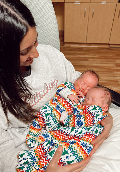 New mother Destiny holds her twin baby girls, Cambrie and Scout. They are still in the hospital after their early birth.