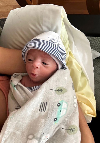 Baby Xavian is sleeping in his mother's arms at CHRISTUS Children's hospital