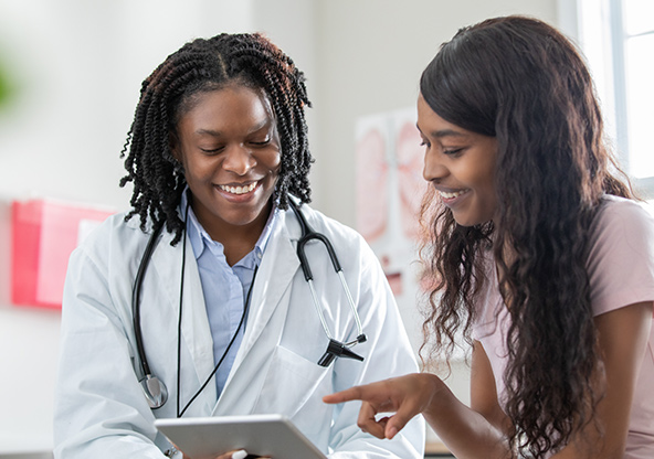 A woman is talking with her doctor about her results